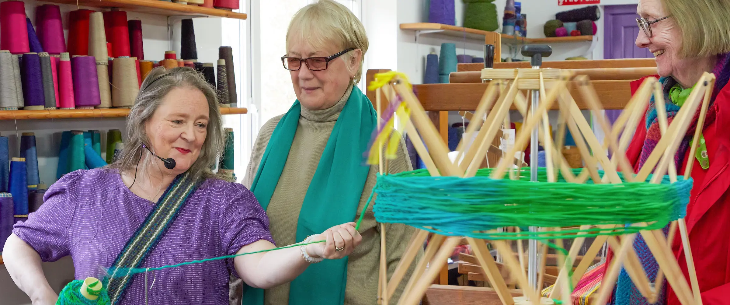 liz-christy-demonstrates-unhanking-her-handdyed-wool-to-a-group-of-visitors